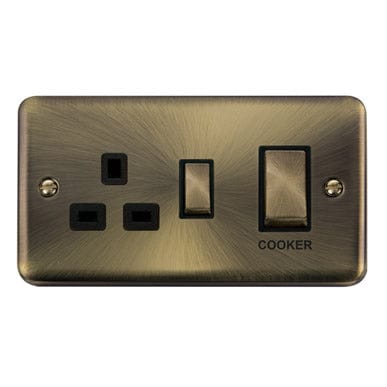 Curved Antique Brass Curved Antique Brass 45A Ingot 2 Gang DP Switch With 13A DP Switched Plug Socket - Black Trim