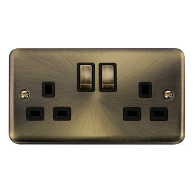 Curved Antique Brass Curved Antique Brass 13A Ingot 2 Gang DP Switched Plug Socket - Black Trim