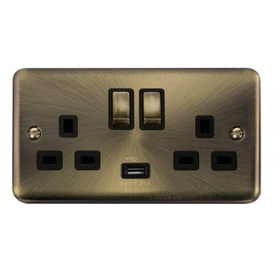 Curved Antique Brass Curved Antique Brass 13A Ingot 2 Gang Switched Plug Socket With 2.1A USB Outlet - Black Trim