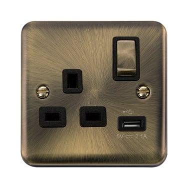 Curved Antique Brass Curved Antique Brass 13A Ingot 1 Gang Switched Plug Socket With 2.1A USB Outlet - Black Trim